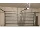 Garage with white sectional door and automatic door opener at 12630 Aston Dr, Hudson, FL 34669