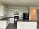 Well-lit kitchen features granite counters, stainless appliances, white cabinetry, and eat-in island at 12630 Aston Dr, Hudson, FL 34669