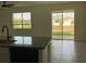 Open kitchen area with sliding glass doors leading to the backyard and natural light at 12630 Aston Dr, Hudson, FL 34669