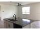 Bright kitchen with large island, granite countertops, undermount sink, and modern fixtures at 12630 Aston Dr, Hudson, FL 34669
