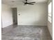 Bright living room features tile flooring, neutral walls, and modern ceiling fan at 12630 Aston Dr, Hudson, FL 34669