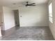 Neutral living room showcases tile flooring, ceiling fan, and a well-lit, spacious area at 12630 Aston Dr, Hudson, FL 34669