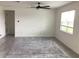 Spacious living room featuring neutral walls, a ceiling fan, and neutral tile flooring at 12630 Aston Dr, Hudson, FL 34669