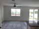Bright living room featuring a window and sliding glass door with backyard views at 12630 Aston Dr, Hudson, FL 34669