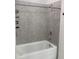 Tiled shower with overhead shower head and built-in shelving for bathroom essentials at 12630 Aston Dr, Hudson, FL 34669