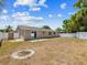 Backyard view featuring a patio, partial vinyl fence and a fire pit at 12709 Cedar Ridge Dr, Hudson, FL 34669