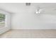 Spacious living room with tile flooring, a ceiling fan, and a window with natural light at 12709 Cedar Ridge Dr, Hudson, FL 34669