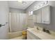 Clean bathroom with a shower-tub combo, neutral color palette, and functional vanity space at 12906 Sandburst Ln, Hudson, FL 34667