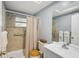Functional bathroom with a shower, toilet, and vanity with ample storage space at 12906 Sandburst Ln, Hudson, FL 34667