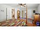 Bedroom featuring a four-poster bed, ceiling fan, and wood-look flooring at 12906 Sandburst Ln, Hudson, FL 34667