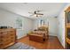 Comfortable bedroom with a four-poster bed, hardwood floors, and natural light streaming through the window at 12906 Sandburst Ln, Hudson, FL 34667