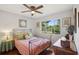 Bedroom with a large window providing natural light and a view of the backyard at 12906 Sandburst Ln, Hudson, FL 34667