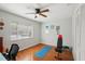 Well-lit room featuring hardwood floors, and a ceiling fan for a comfortable workspace at 12906 Sandburst Ln, Hudson, FL 34667