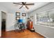Hardwood floors, a ceiling fan, and natural light create an inviting space for work or rest at 12906 Sandburst Ln, Hudson, FL 34667