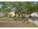 Charming single-story home featuring a well-manicured lawn and mature trees at 12906 Sandburst Ln, Hudson, FL 34667