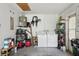 Functional garage space with laundry facilities, storage shelves, and ample room for parking at 12906 Sandburst Ln, Hudson, FL 34667