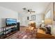 Bright and airy living room with hardwood floors and a ceiling fan at 12906 Sandburst Ln, Hudson, FL 34667