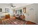 Cozy living room featuring a ceiling fan, hardwood floors, and natural light at 12906 Sandburst Ln, Hudson, FL 34667