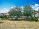 Backyard featuring an iron fence, lush landscaping, and a patio area for outdoor relaxation at 13111 Precept Way, Hudson, FL 34669