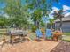 Charming backyard featuring a brick patio, BBQ grill, comfortable seating, and well-manicured landscaping at 13111 Precept Way, Hudson, FL 34669