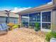 Inviting screened-in patio and lush, landscaped backyard, perfect for outdoor gatherings and relaxation at 13111 Precept Way, Hudson, FL 34669