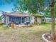 Expansive backyard features an outdoor patio, mature trees, lush landscaping, and a peaceful, relaxing view at 13111 Precept Way, Hudson, FL 34669