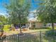 Private backyard with metal fencing, lush lawn, mature trees, and screened in patio at 13111 Precept Way, Hudson, FL 34669