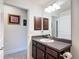 Bathroom features a granite countertop vanity, mirror, and ample lighting at 13111 Precept Way, Hudson, FL 34669