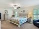 Well-decorated bedroom with a large bed, dresser, and side tables at 13111 Precept Way, Hudson, FL 34669