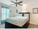 Comfortable bedroom with a ceiling fan and natural light from the window at 13111 Precept Way, Hudson, FL 34669