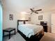 Comfortable bedroom featuring a ceiling fan, side table, and tasteful decor at 13111 Precept Way, Hudson, FL 34669