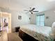 Bright bedroom showcasing a ceiling fan, adjacent hall, and natural light at 13111 Precept Way, Hudson, FL 34669