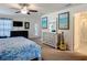 Bedroom with guitar, dresser, TV, and walk-out door at 13111 Precept Way, Hudson, FL 34669