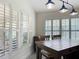 Bright dining area with plantation shutters, modern lighting, and a spacious layout for gatherings at 13111 Precept Way, Hudson, FL 34669