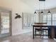 Light-filled dining area with plantation shutters, rustic wooden table, and seamless transition to outdoor spaces at 13111 Precept Way, Hudson, FL 34669