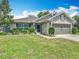 Charming home with a well-kept lawn and a two-car garage at 13111 Precept Way, Hudson, FL 34669