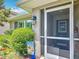 Welcoming front screened entrance with decorative touches, surrounded by lush landscaping and a charming welcome sign at 13111 Precept Way, Hudson, FL 34669