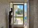 Inviting screened front entrance showcasing decorative details and a glimpse of the well-kept front yard at 13111 Precept Way, Hudson, FL 34669