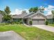 Charming single-story home with a well-manicured lawn and inviting curb appeal on a sunny day at 13111 Precept Way, Hudson, FL 34669