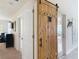 Hallway features a sliding barn door accent adding character to the space at 13111 Precept Way, Hudson, FL 34669