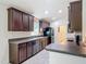 Well-equipped kitchen with dark wood cabinets, stainless steel appliances, ample counter space, and modern finishes at 13111 Precept Way, Hudson, FL 34669