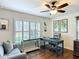 Inviting office space with hardwood floors, plantation shutters, a ceiling fan, and a comfortable seating area at 13111 Precept Way, Hudson, FL 34669
