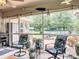 Relaxing screened patio with comfortable seating, stylish plants, and an outdoor cooking area for entertaining guests at 13111 Precept Way, Hudson, FL 34669