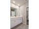 Bright bathroom featuring a double sink vanity with quartz countertops and access to the bedroom at 13205 Arkendale St, Spring Hill, FL 34609