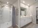 Bathroom featuring a curved shower stall and a double sink vanity with modern fixtures and ample storage space at 13205 Arkendale St, Spring Hill, FL 34609