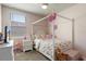 Bright bedroom features a four-poster bed, soft carpet, a ceiling fan, and a view from the window at 13205 Arkendale St, Spring Hill, FL 34609