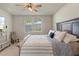 Bedroom with modern decor, ceiling fan, a large bed, a dresser, and window with backyard views at 13205 Arkendale St, Spring Hill, FL 34609