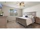 Bedroom with window views, ceiling fan, carpet, and a large bed with decorative pillows at 13205 Arkendale St, Spring Hill, FL 34609