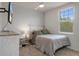 Cozy bedroom features a ceiling fan and a large window offering natural light at 13205 Arkendale St, Spring Hill, FL 34609