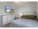 Comfortable bedroom featuring a dresser and TV for relaxing after a long day at 13205 Arkendale St, Spring Hill, FL 34609